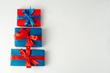 Blue and red three gift boxes isolated over white background. Christmas, party or birthday concept. Copy space.