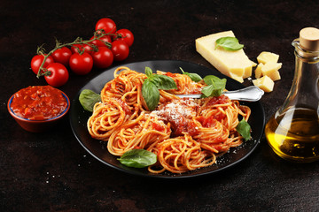 Plate of delicious spaghetti Bolognaise or Bolognese with savory minced beef and tomato sauce garnished with parmesan