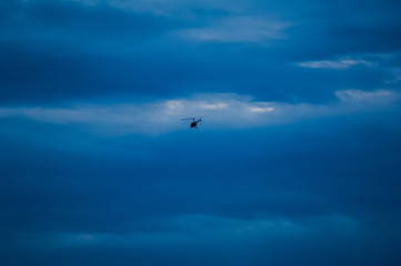 Fototapeta na wymiar helicopter against the blue sky