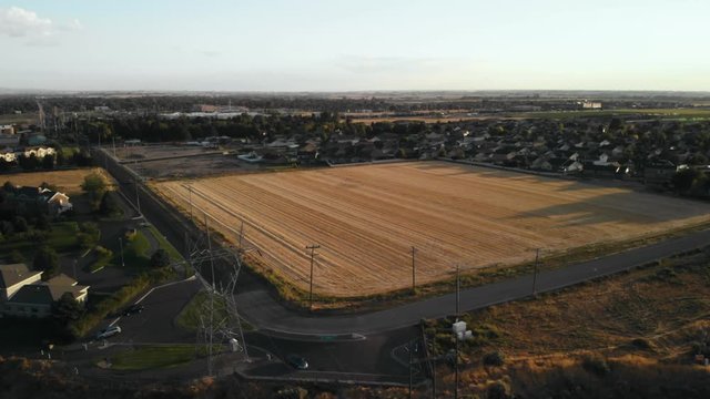 Aerial footage rotating around a crop field in the middle of an built up urban area near Twin Falls, Idaho, USA
