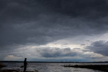 fisherman on the background of the lake