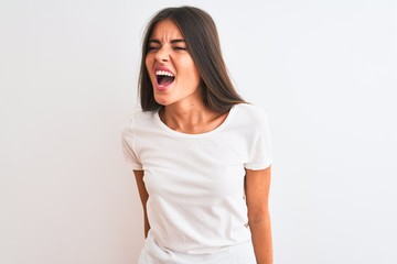 Fototapeta premium Young beautiful woman wearing casual t-shirt standing over isolated white background angry and mad screaming frustrated and furious, shouting with anger. Rage and aggressive concept.