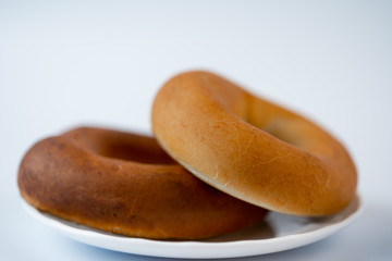 Big bagels on a saucer on a white background