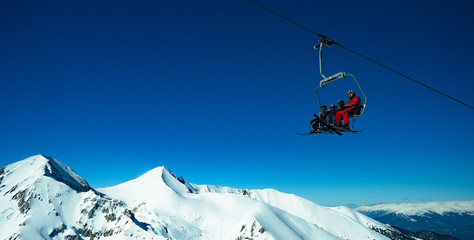 people on a ski lift in the mountains