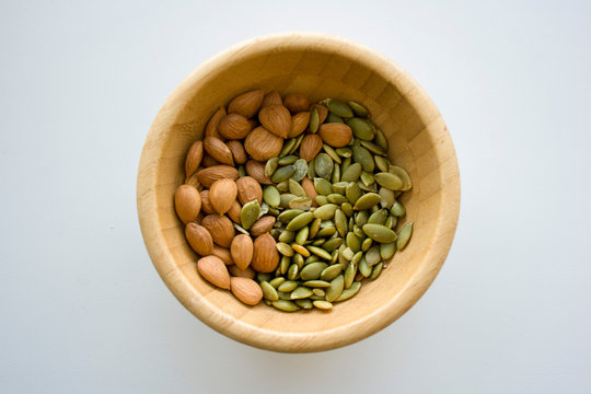 Mix with almonds, and pumpkin seeds in a wooden bowl