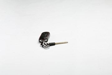 The car key with black leather keychain closeup on white background. nice gift for women 