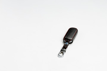 The car key with black leather keychain closeup on white background. nice gift for women 