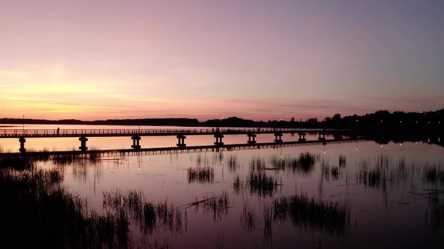 Sunset by the lake Sirvena in Birzai - the longest wooden bridge in Lithuania.The bridge is located in Birzai Regional Park, connecting Birzai with Astravas Manor on the northern edge of the lake