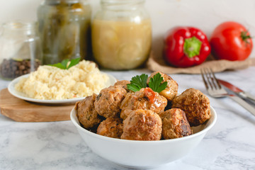 Pork meatballs in tomato sauce served with couscous
