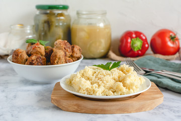Couscous on plate served with homemade pork meatballs