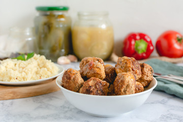 Pork meatballs in tomato sauce served with couscous
