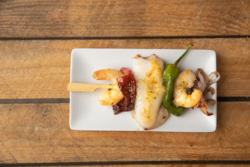 Skewer of sepia peppers and shrimp, typical Spanish tapa