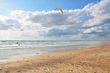 Kitesurfer rushing along the waves of the Atlantic Ocean. Saint-Pierre-Quiberon‎, Brittany. France