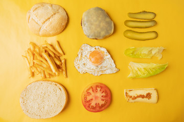Ingredients for making hamburger on yellow background