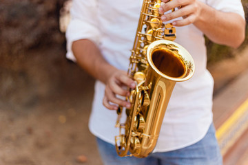 Obraz premium Close up of a man passionately playing the saxophone at the street