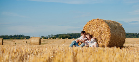 Happy young couple on straw, romantic people concept, beautiful landscape, summer season
