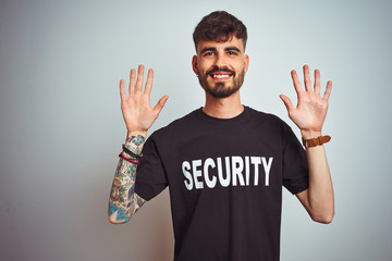 Young safeguard man with tattoo wering security uniform over isolated white background showing and...