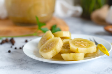 Marinated cucumber on a plate on the kitchen table