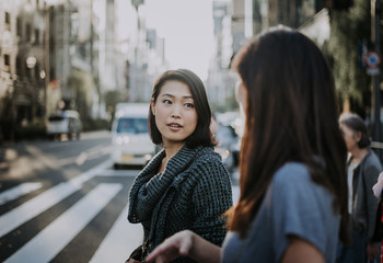 Fototapeta premium Two japanese women around in Tokyo during daytime. Making shopping and having fun