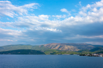 Picturesque landscape with dark blue clouds, mountains and sea