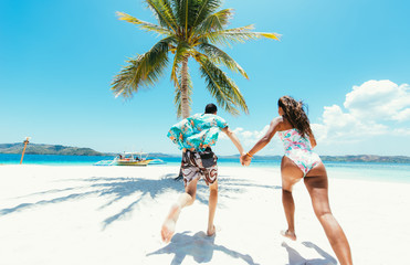 Couple spending time on a beutiful remote tropical island in the philippines. Concept about vacation and lifestyle.