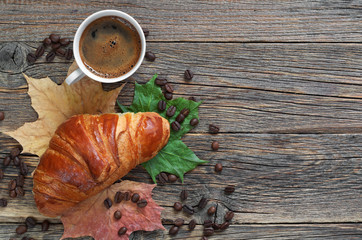 Coffee, croissant and leaves