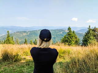 Young girl standing on the top of the Carpathian mountains