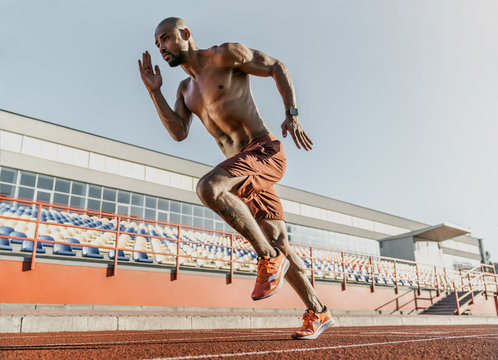 African runner athlete sprinting on running track at the stadium