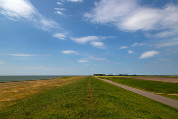 Typical rural landscape with dike of southwestern part of Dutch province Friesland