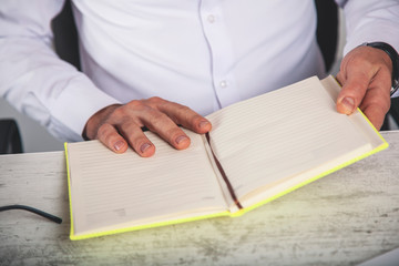 man hand holding notepad