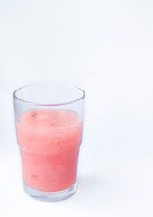 Drinking yogurt in a glass on a white background, copy space. Delicious pink fruit yogurt. Natural detoxification. Healthy eating concept. Fresh homemade yogurt for Breakfast. Fruit yogurt smoothie.