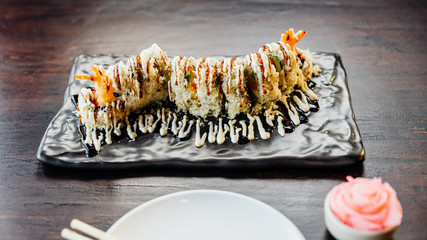 Maki Sushi with Rice, Shrimp Tempura, Avocado and Cheese inside covered Crispy Tempura Flour. Topping with Teriyaki Sauce and Mayonnaise.