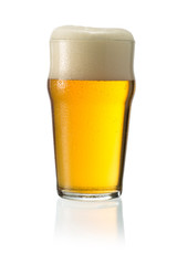 Glass of blonde beer with foam