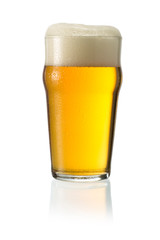 Glass of blonde beer with foam