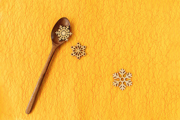 Christmas background with wooden spoon and snowflakes. Holiday cooking, festive recips, celebration concept