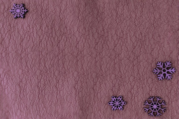 Abstract christmas purple background, violet wooden snowflakes. Dark backdrop for design, copy space