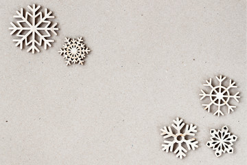 Abstract christmas natural background with wooden snowflakes. Vintage backdrop for design, copy space