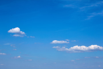 Background of blue sky with clouds close up. White fluffy clouds.