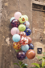 Colored balloons hanging on a wall