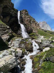 Fototapeta na wymiar Waterfall in the mountains- Cervino Waterfall - Breuil-Cervinia, Italy