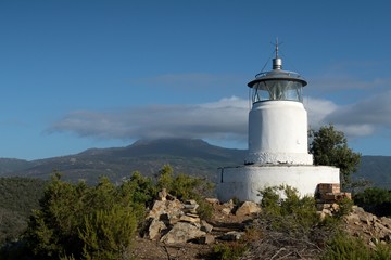 Fototapeta na wymiar Monte Poro Lighthouse near Marina di Campo on the island Elba in Italy