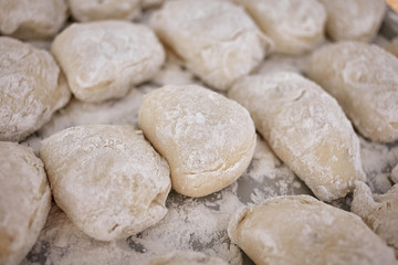 Fototapeta na wymiar National Ukrainian food. Many delicious dumplings on a tray close-up.