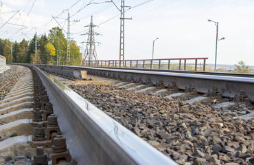 Fototapeta na wymiar Railroad track, railway landscape. Metal sleepers on the railway. Low angle shot.