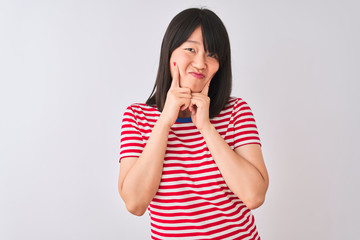 Young beautiful chinese woman wearing red striped t-shirt over isolated white background Smiling with open mouth, fingers pointing and forcing cheerful smile