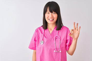 Young beautiful Chinese nurse woman wearing stethoscope over isolated white background showing and pointing up with fingers number three while smiling confident and happy.