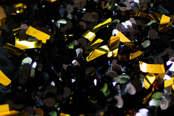 Golden confetti on black background