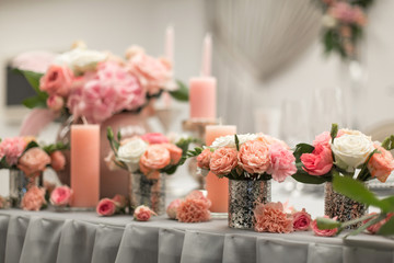 Decor for the holiday table. Natural flowers candle holders in pink colors.