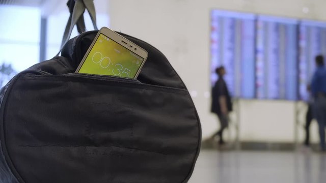 bag of explosives left by terrorist at airport. Blurred background. Countdown timer in bag with bomb at airport, terrorist attack.
