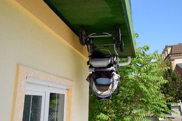 baby stroller in house upside down. the house is the opposite.