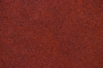 Fototapeta premium Red rubber coating for the Playground. The wheels are recycled and turned into a useful coating for the Playground. Rubber background painted in crimson color